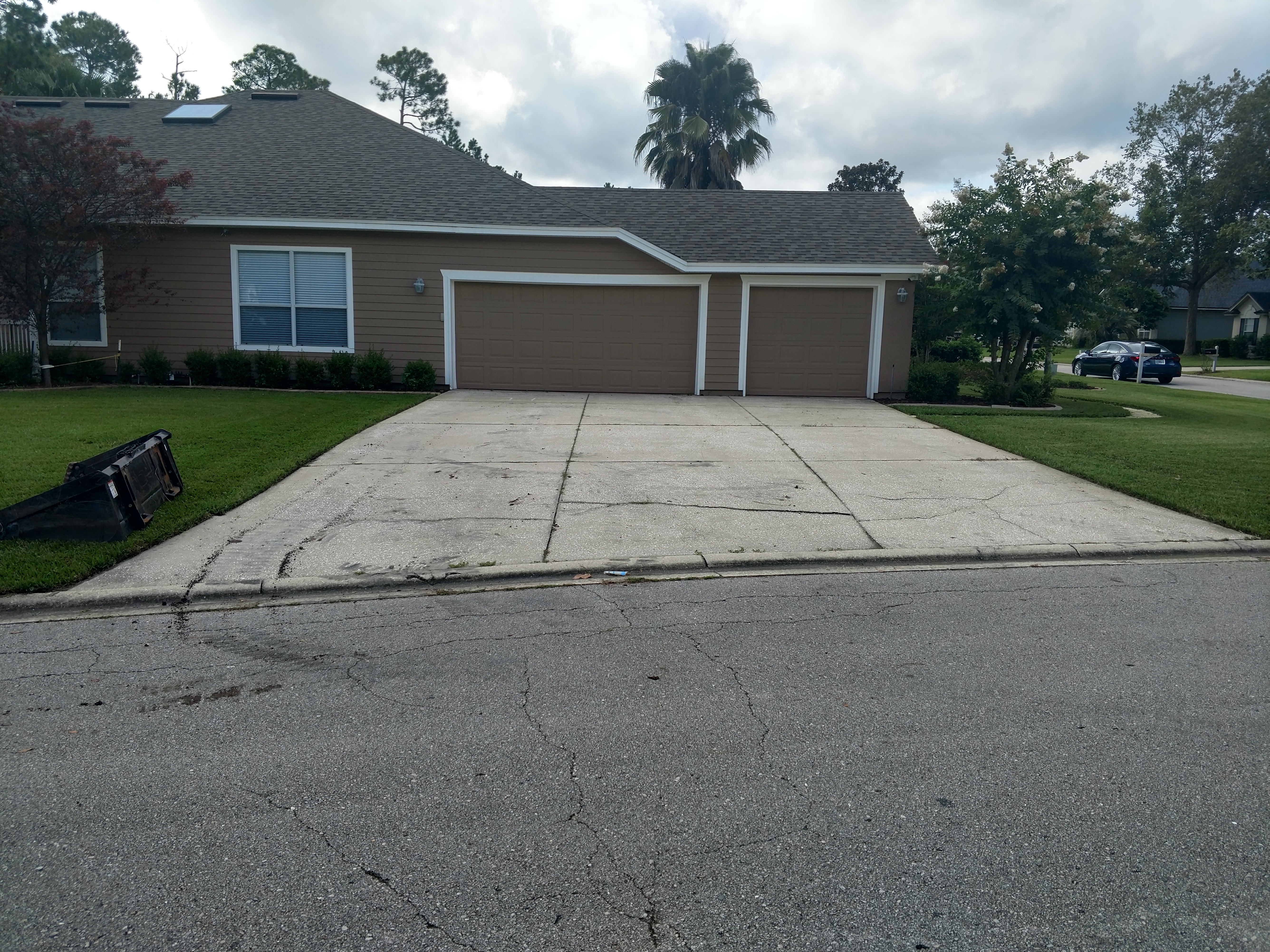 Before — deteriorated concrete driveway St Johns