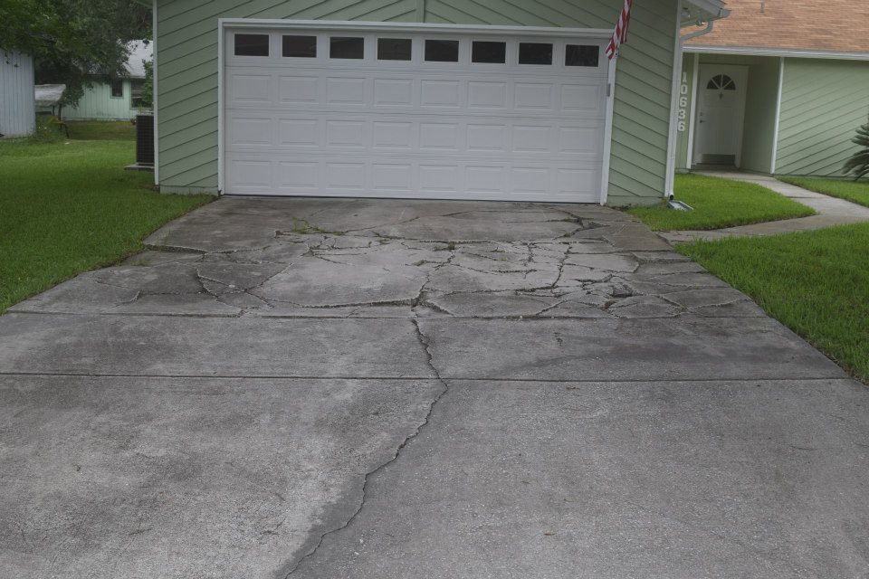 Before — cracked concrete driveway Jacksonville
