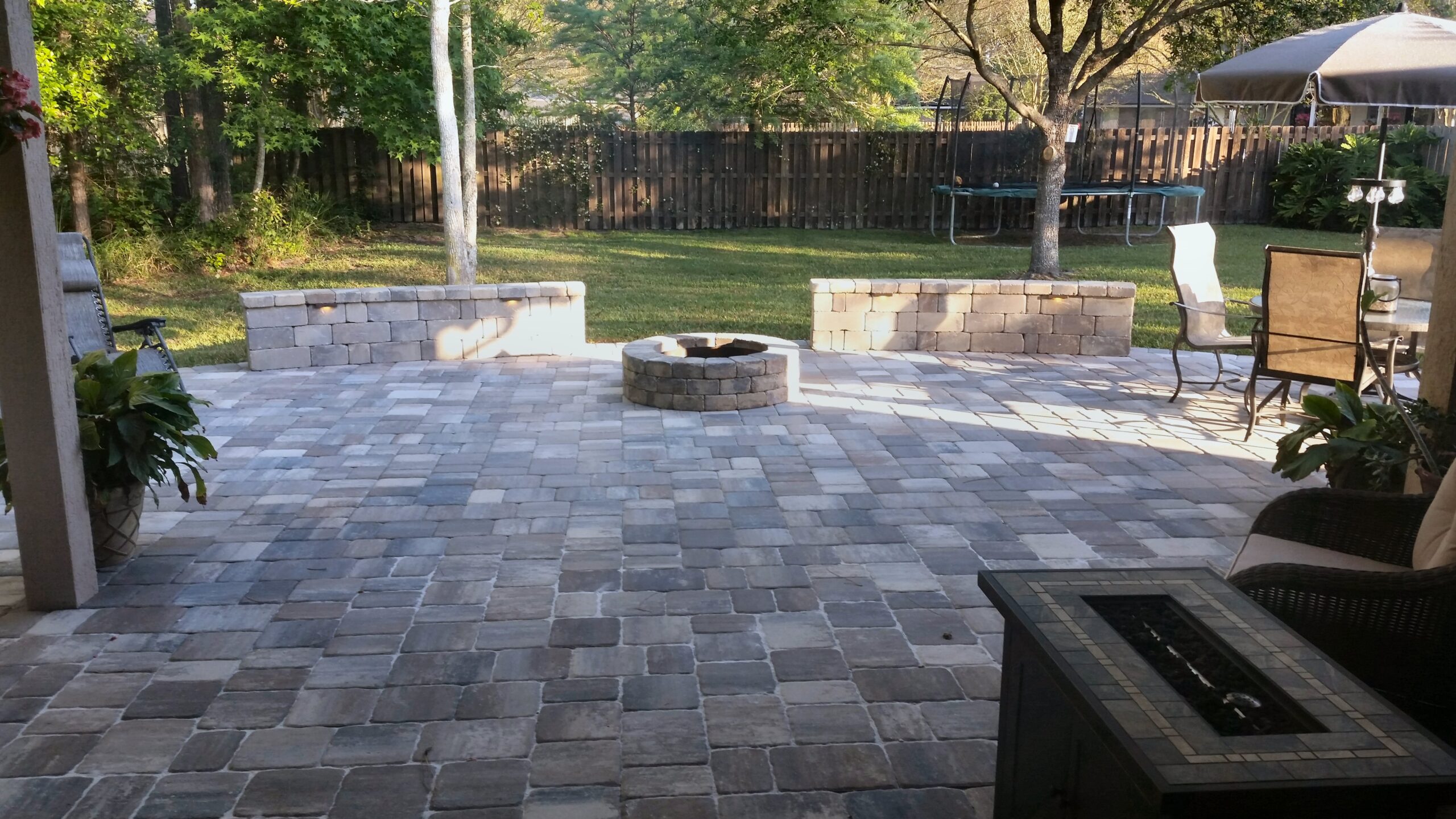 Paver patio with fire pit and outdoor lighting Nassau County